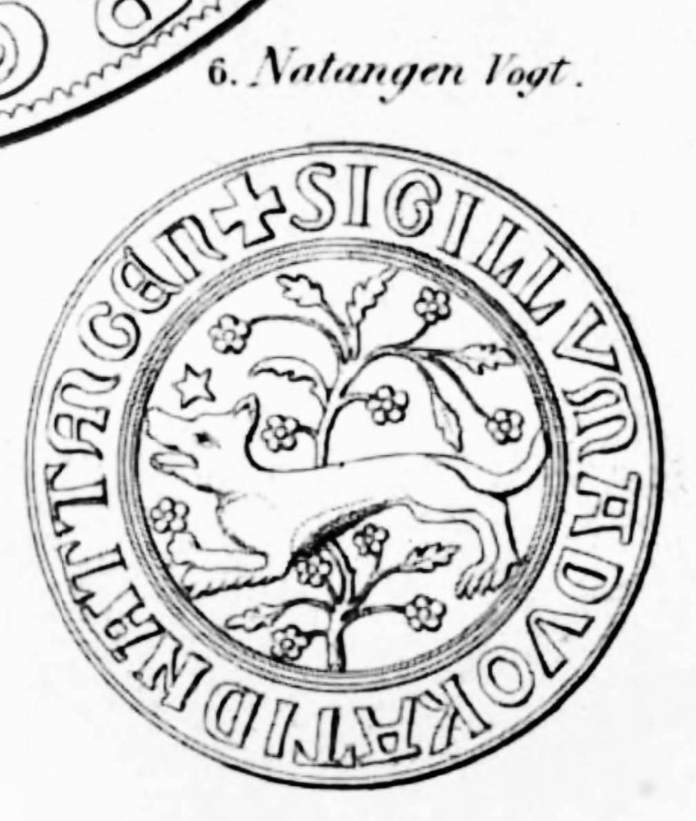 Das Bild zeigt eine schematische Darstellung des Siegels des Vogtes von Natangen. Darauf abgebildet ist ein nach links laufender Wolf vor einem blühenden Strauch